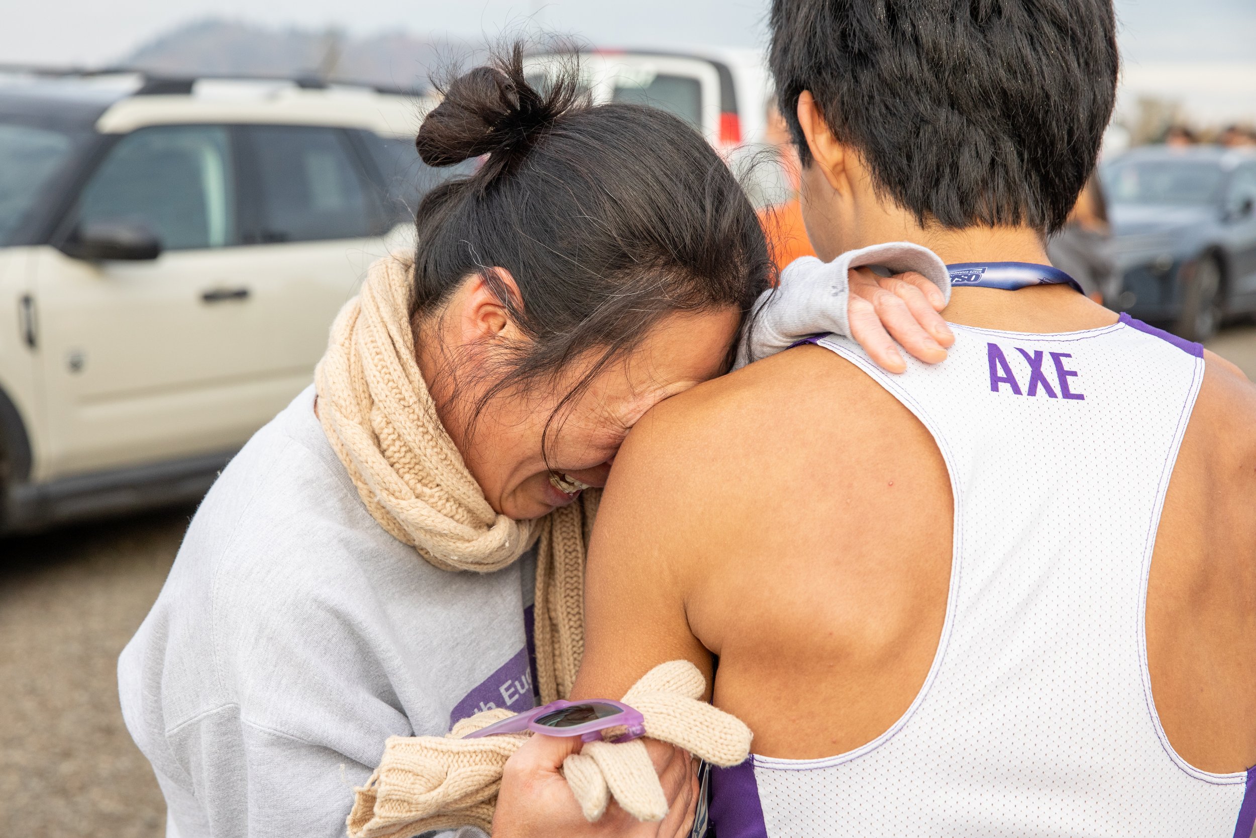  Tomoko Shibata cries into her son Yosuke Shibata's shoulder after he took first place for South Eugene High School in the 6A division of the OSAA State Cross-Country Championships on Nov. 8, 2025. 