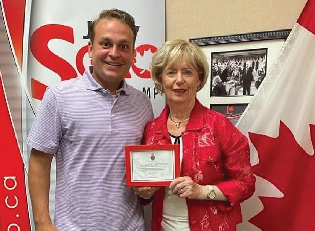 Receiving the Canadian Heraldic Platinum Jubilee Award for Outstanding Community Leadership by The Honorable Judy A. Sgro, Member of Parliament