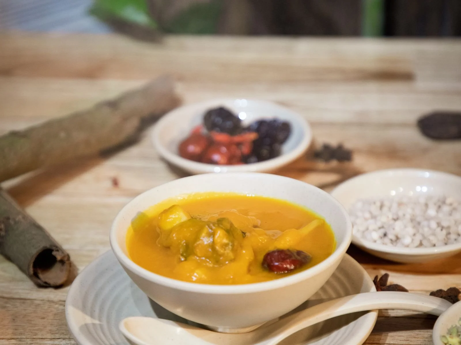 Bowl of creamy orange pumpkin curry served over white rice with fresh herbs
