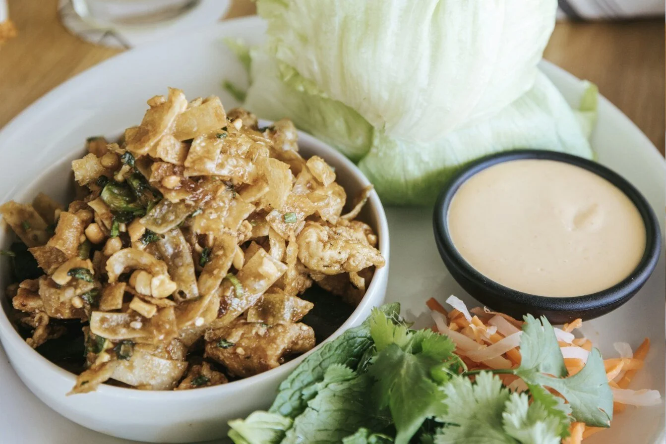 Butter lettuce cups filled with seasoned ground meat, diced peppers and green onion