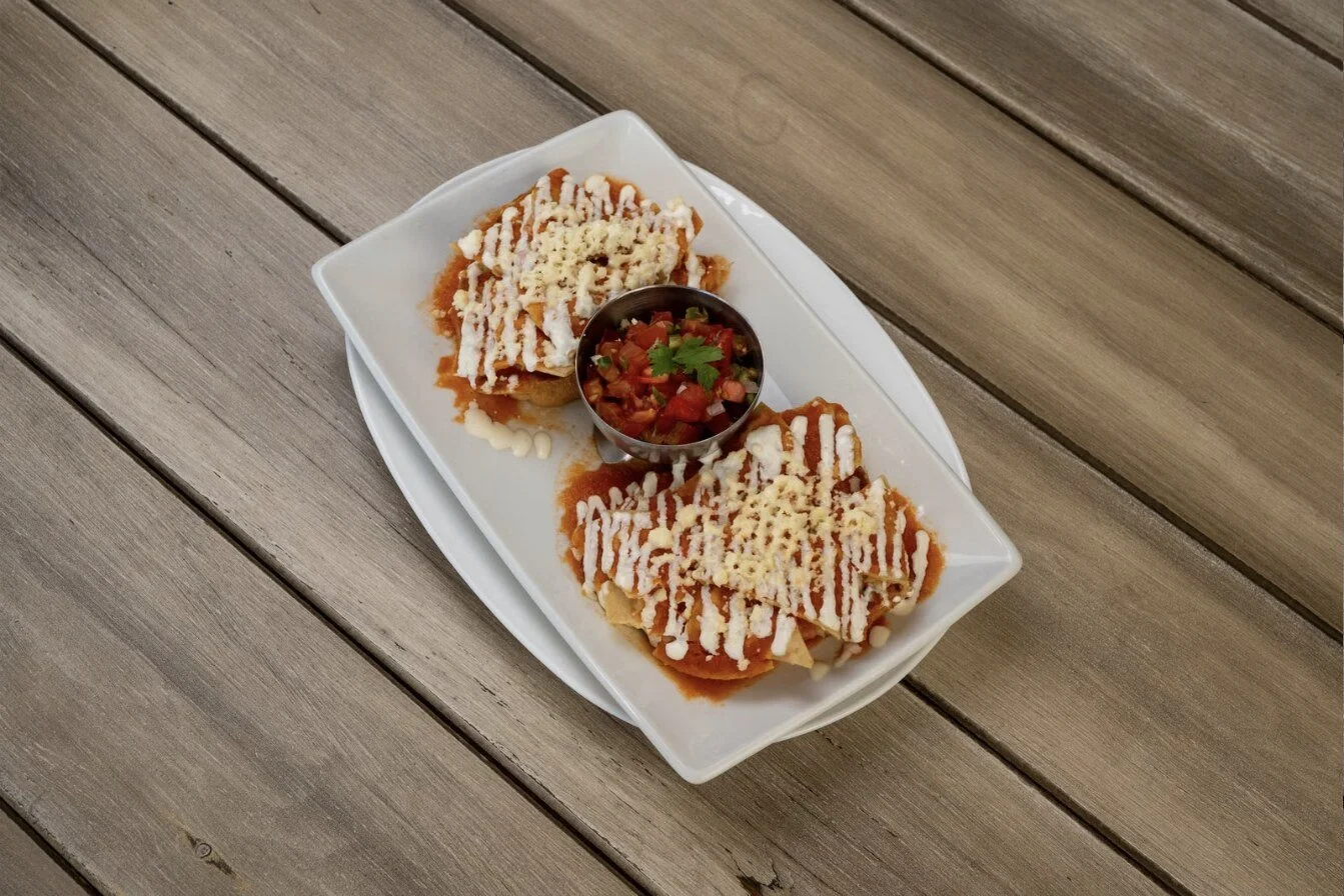 Skillet enchiladas topped with red sauce, melted cheese and chopped cilantro