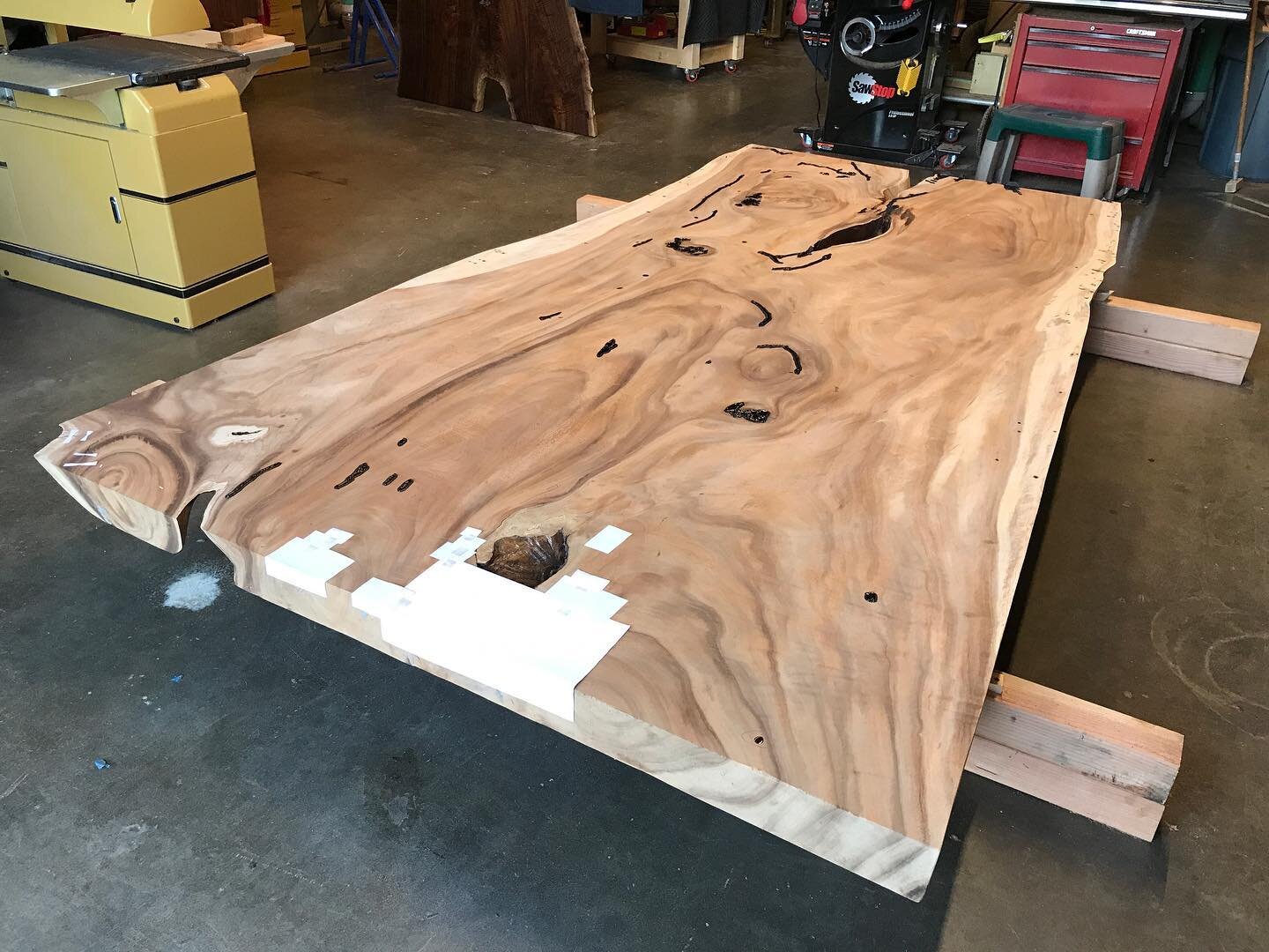 @bubingawoodworks  working on epoxy fills and a patching strategy for this slab table restoration. Thanks to @wood__walker at @lorenwoodbuilders for tips on how to caulk around the voids to contain the epoxy.

#slabtable #furnituredesign #liveedgefur