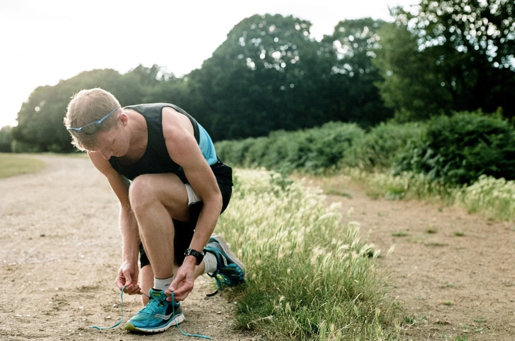 James Williams Tying Shoes in Park for JamesRunsFar.com.jpg