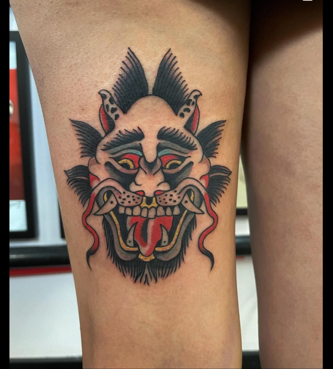  Tattoo of head of a mythical creature.  