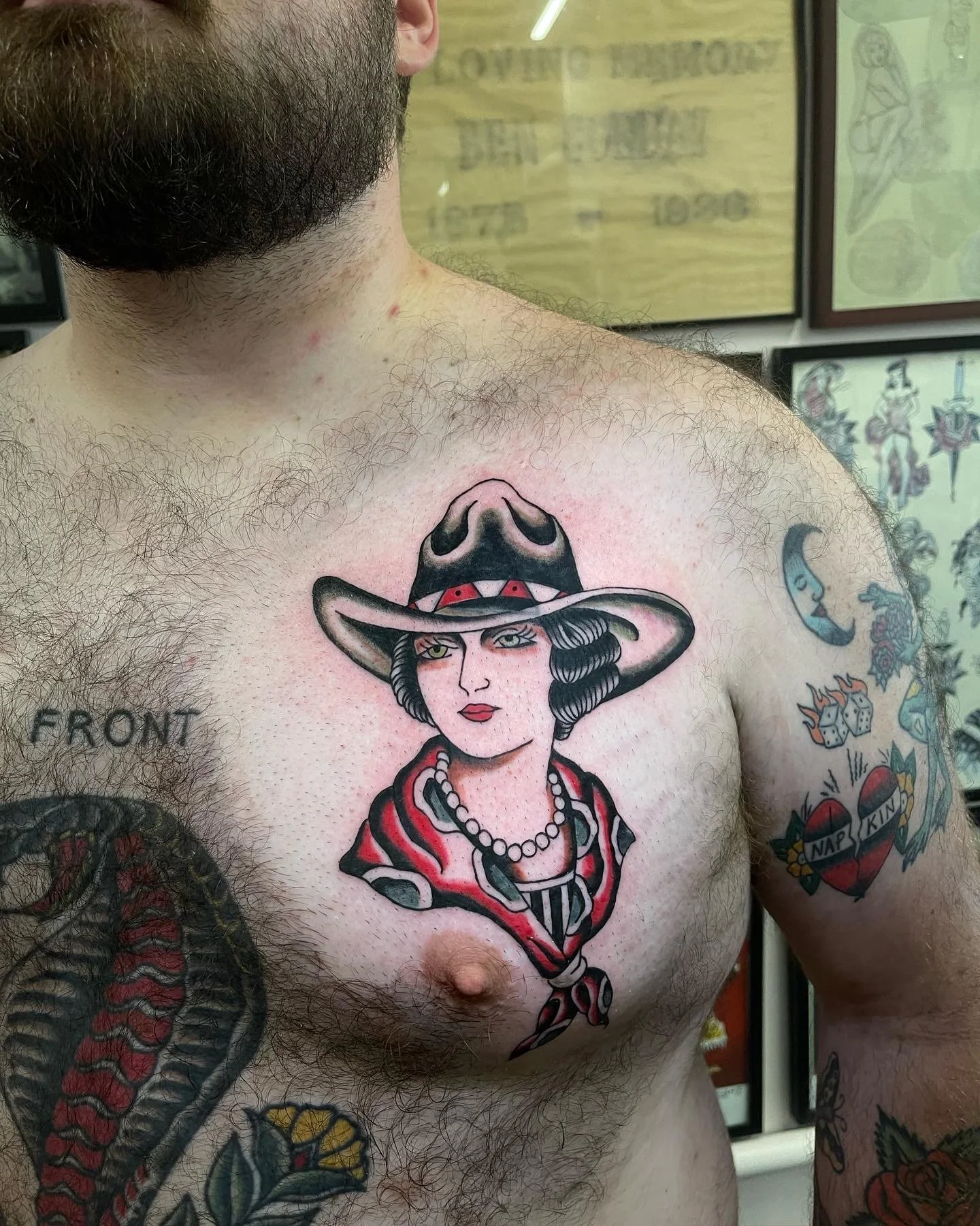  Tattoo of cowgirl head with cowgirl hat and scarf on pec.  