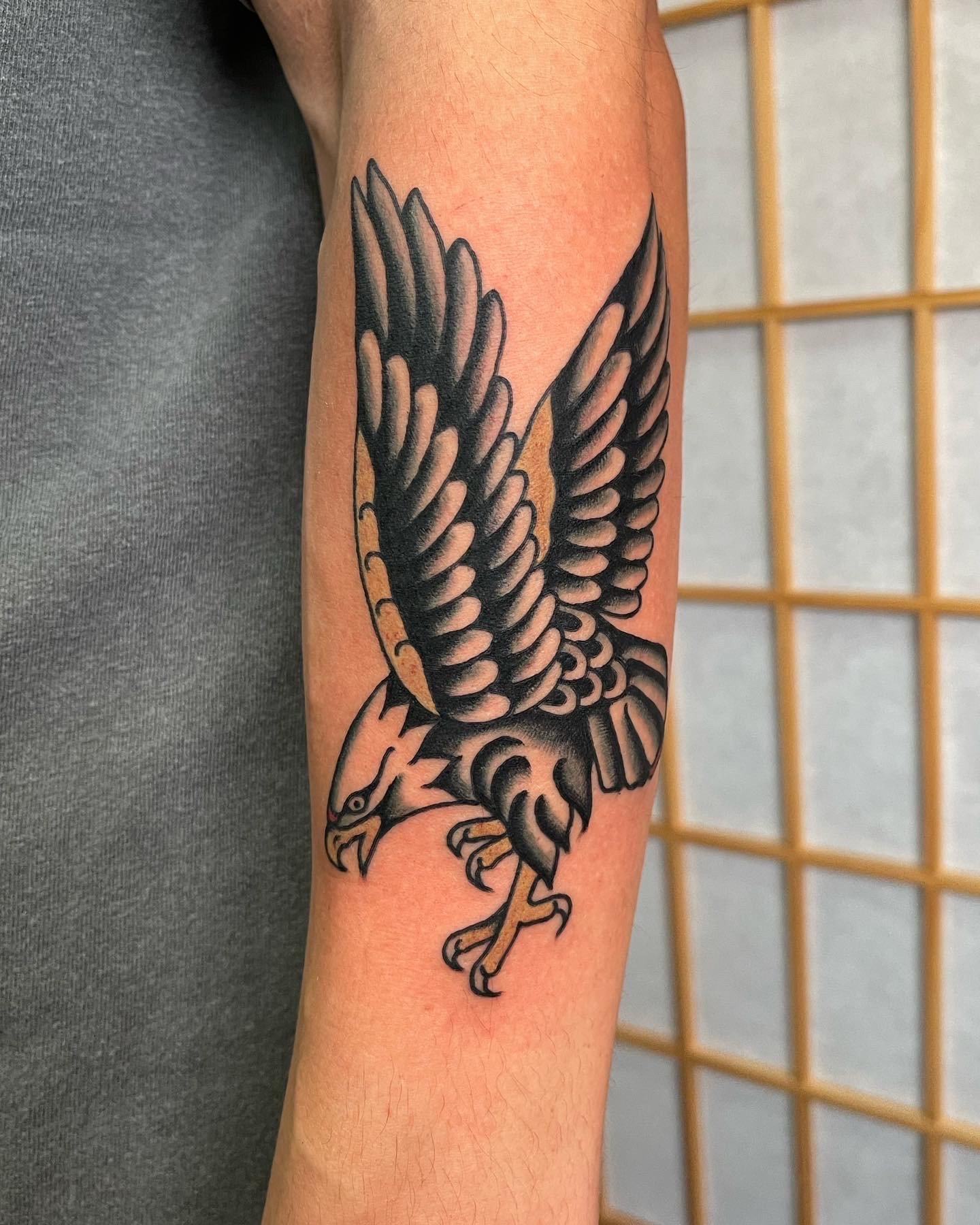  Black and grey eagle tattoo on lower arm.  