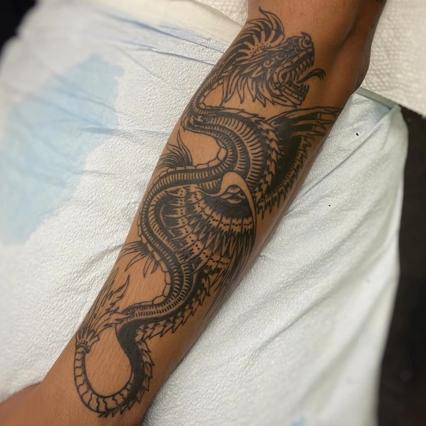 Black & grey dragon tattoo on arm