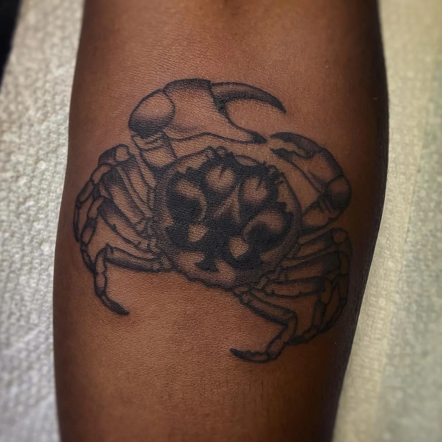 Black & grey tattoo of crab
