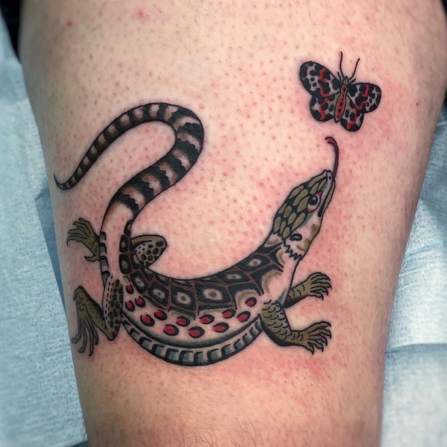 Tattoo of a retile trying to catch a butterfly