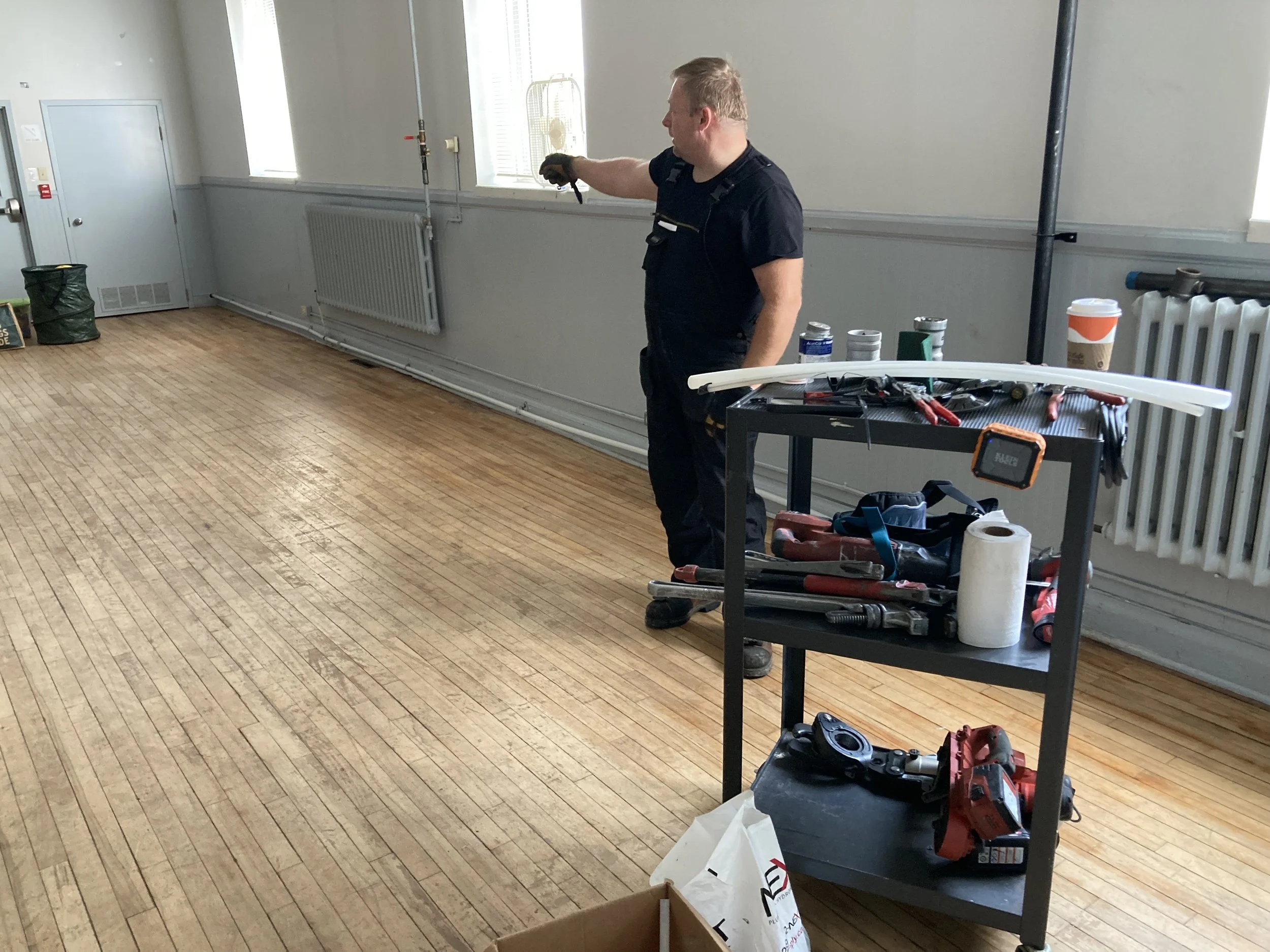 Aaron pointing out what's left to do.jpeg