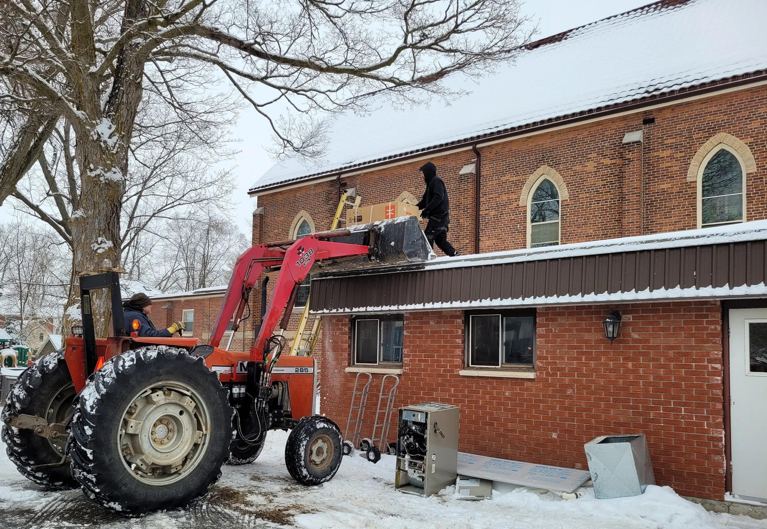 Ross Carlisle lifting heat pump to the roof.jpg