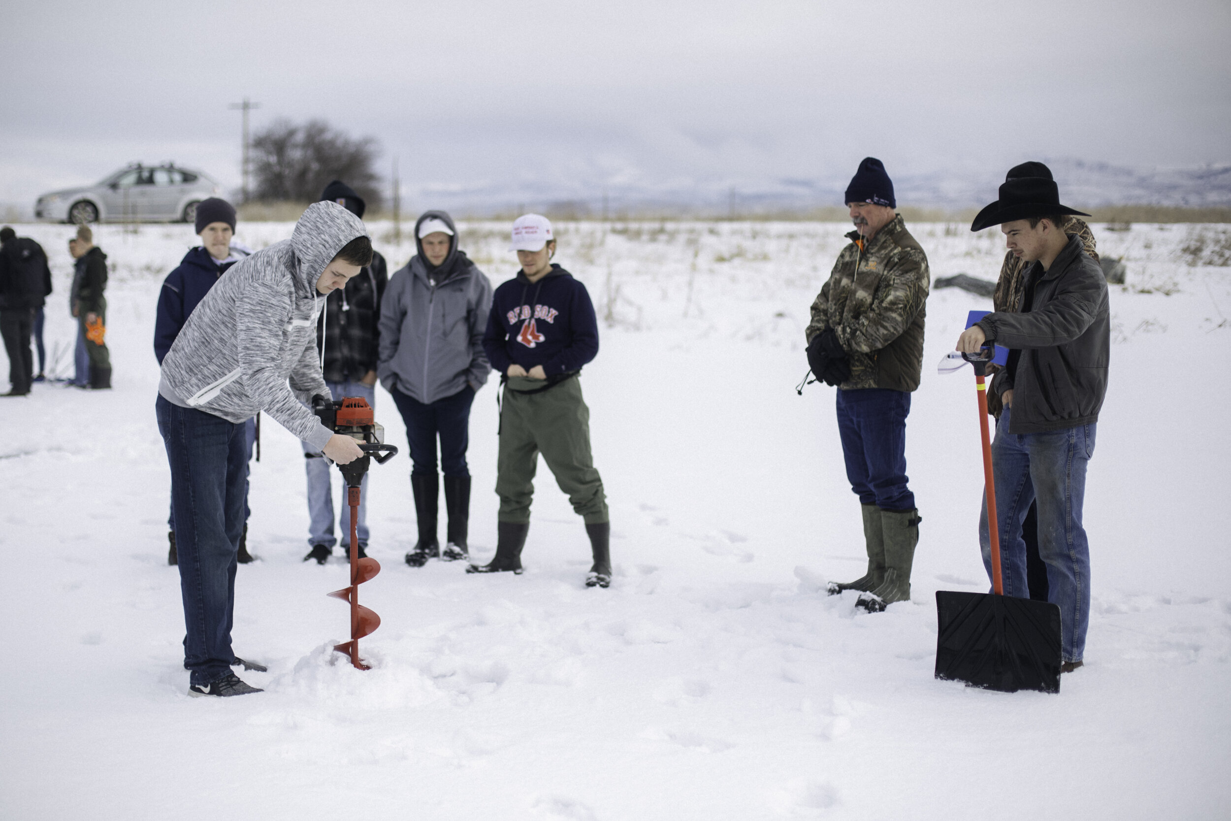  Hamilton High School students drill holes in 16 inch ice on Thomas Pond to conduct water chemistry studies. The data will guide future management of pond stocking to ensure fish survivability through winter months.     