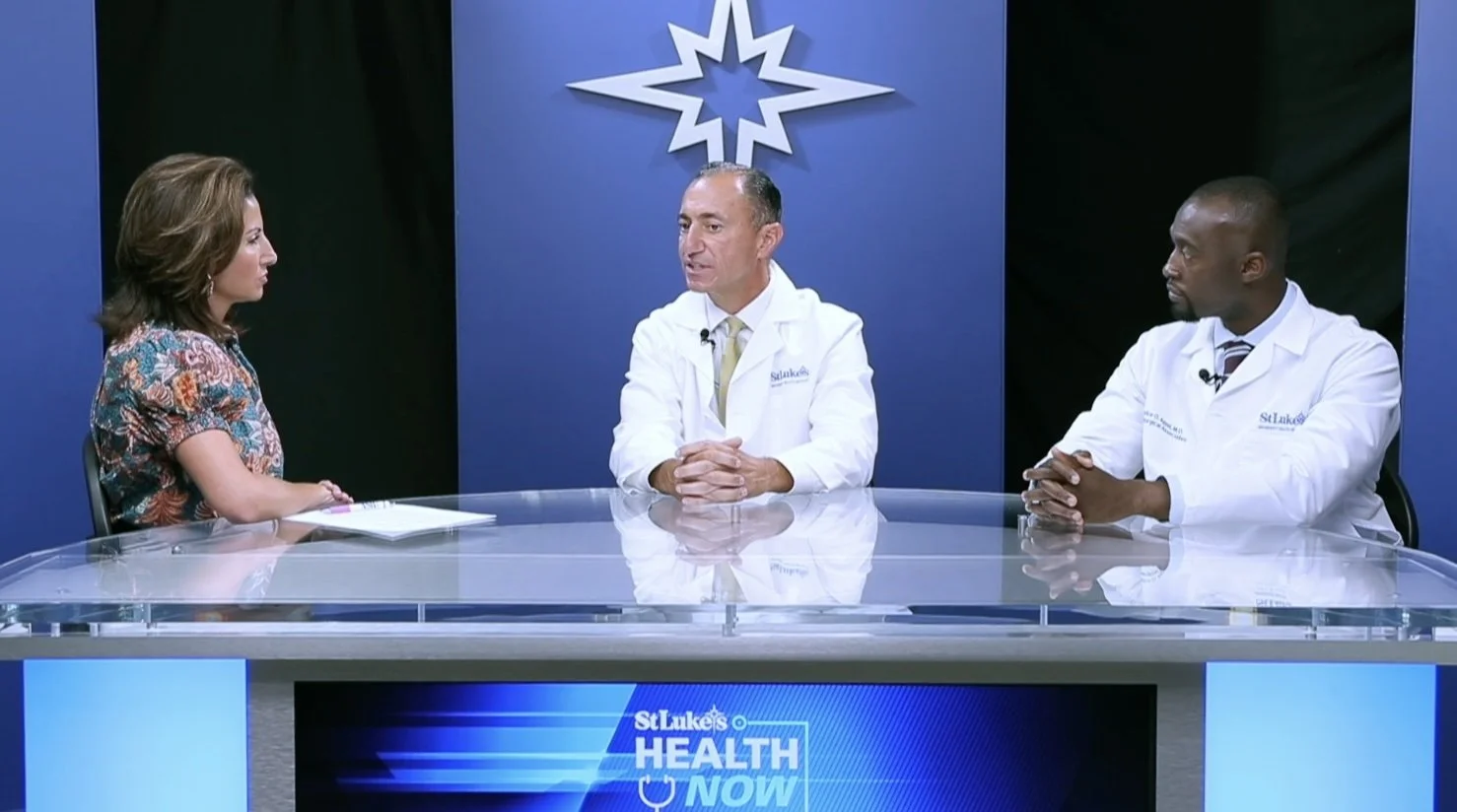 Ashley Russo sitting with two doctors