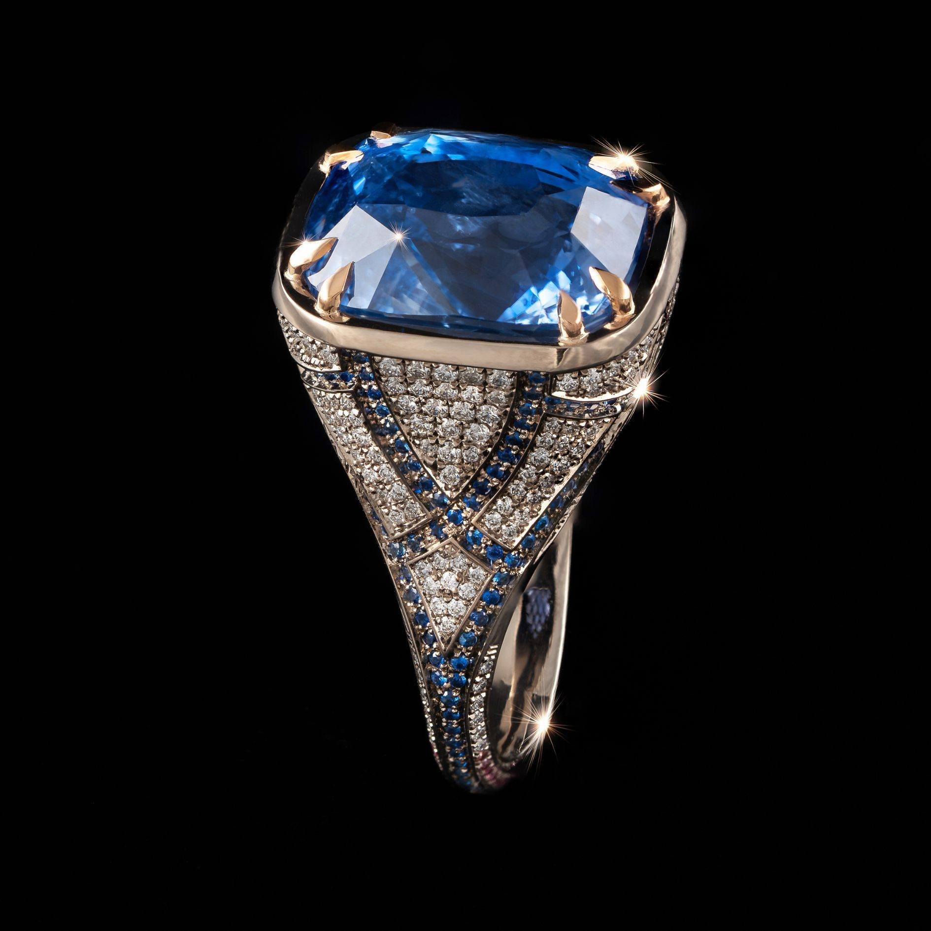 Neptune Ring | A private commission: An exquisite 18kt white gold ring featuring a client's heirloom stunning blue sapphire centre stone. Surrounding the sapphire, Nigel hand-set sixty-four pink diamonds, with two hundred and thirty-six white diamond