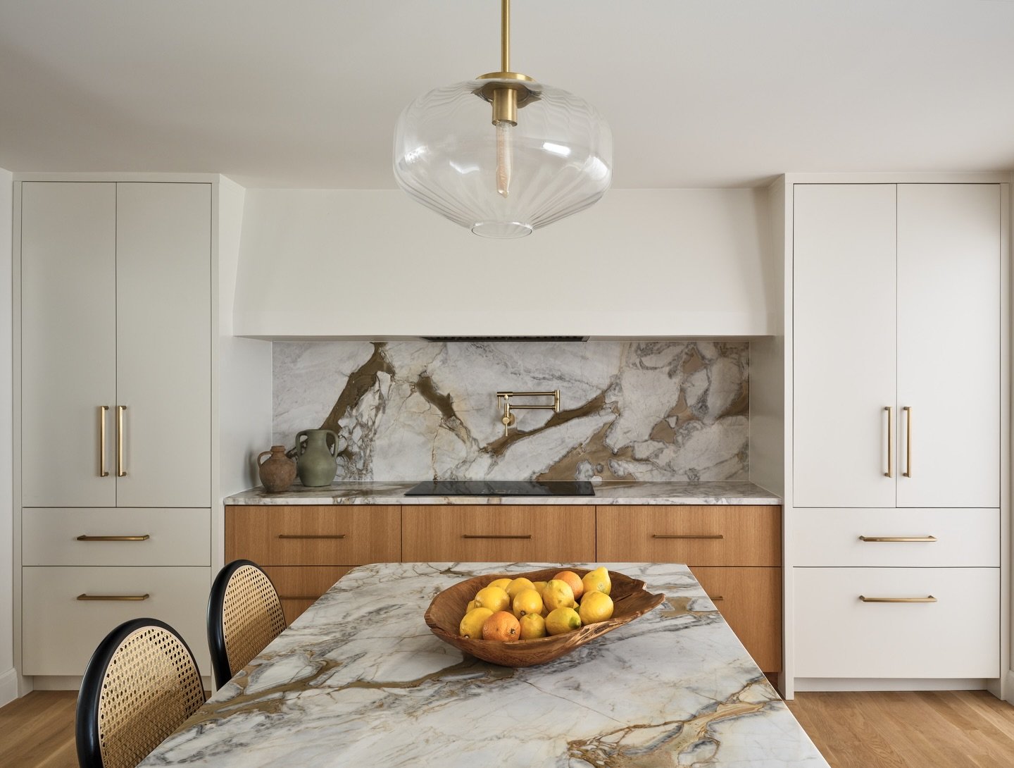 Utilizing panel-ready appliances can impact the design in a major way. In our Westport kitchen, the refrigerator/freezer combination from Thermador is indistinguishable from the pantry on the left. This allows for a symmetrically balanced design with