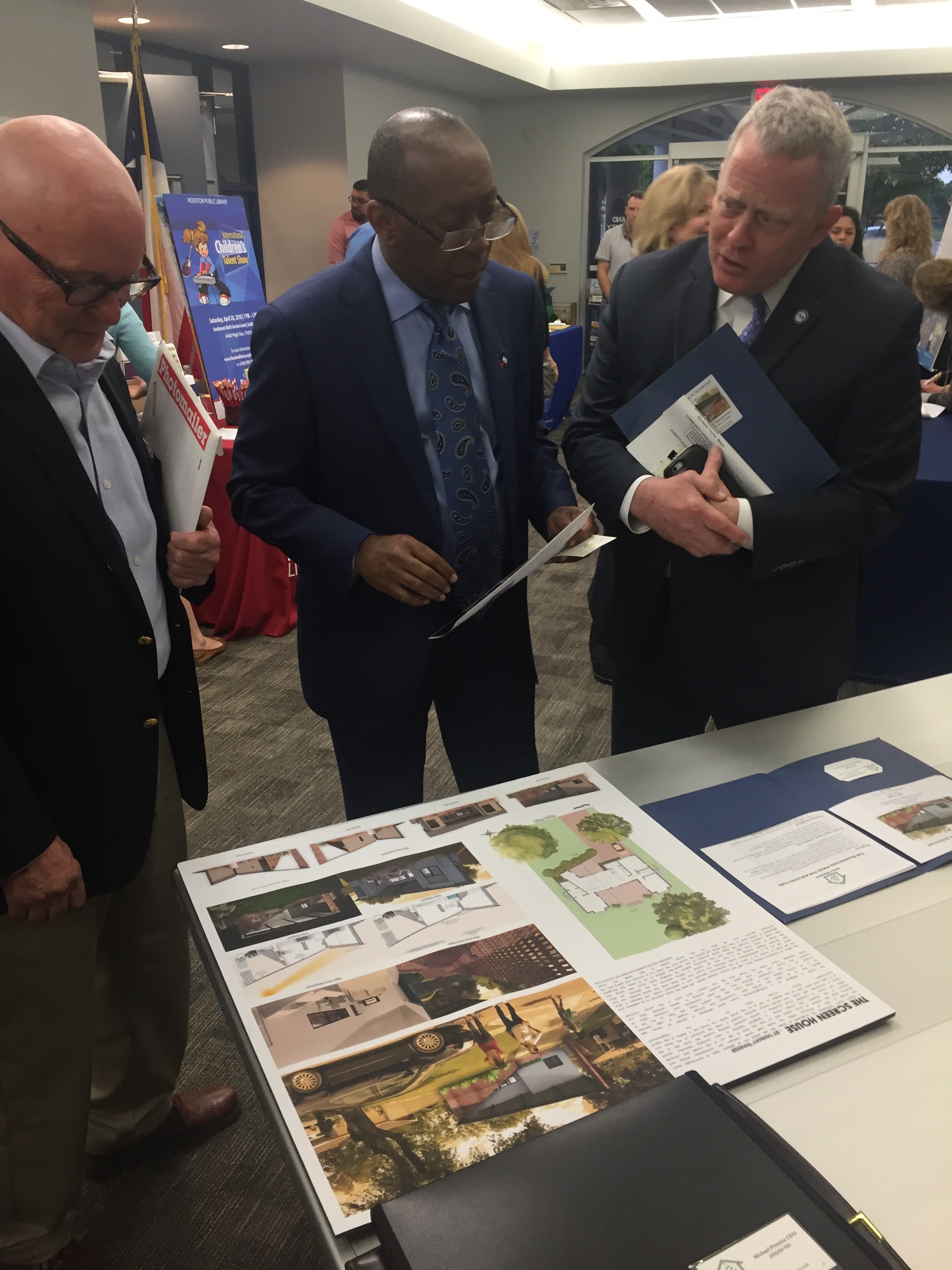   Michael Prentice showing display of winning design for the Sharpstown Prize for Architecture to Houston Mayor Sylvester Turner and Houston City Councilman David Robinson during the District J community meeting.  