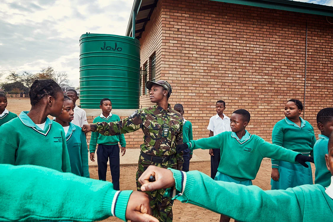 Black Mamba Nkateko Mzimba shows students how to properly stand at attention, Foskor Primary School, South Arica, 2017.