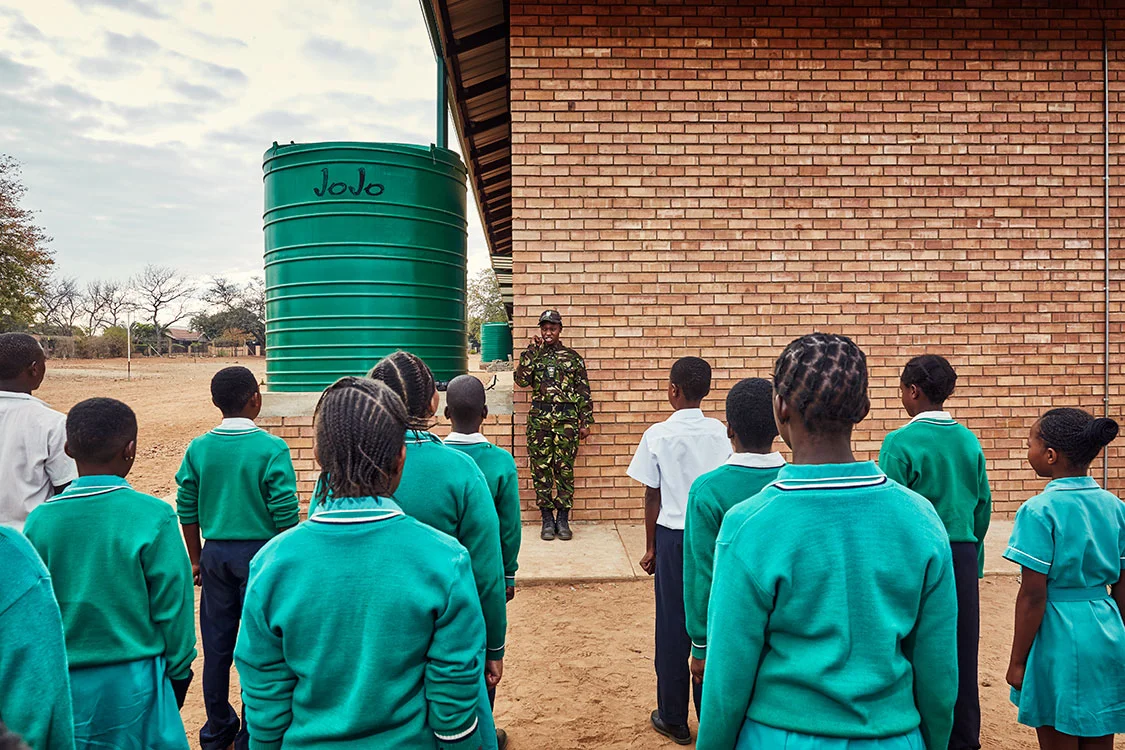 Black Mamba scout Nkateko Mzimba shows students how to properly stand at attention, Foskor Primary School, South Arica, 2017.