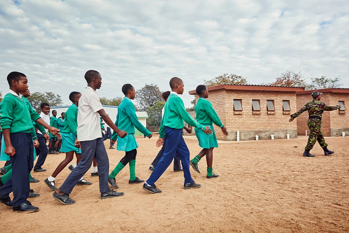 Black Mamba scout Nkateko Mzimba shows students how to properly stand at attention, Foskor Primary School, South Arica, 2017.