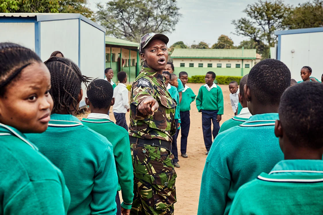 Black Mamba scout Nkateko Mzimba shows students how to properly stand at attention, Foskor Primary School, South Arica, 2017.