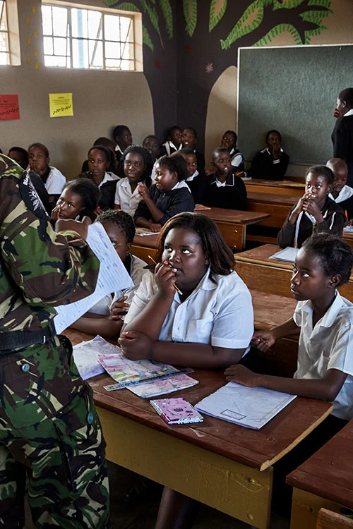 Black Mamba Nkateko Mzimba talks to children at Maseke Primary School, South Africa, 2017.