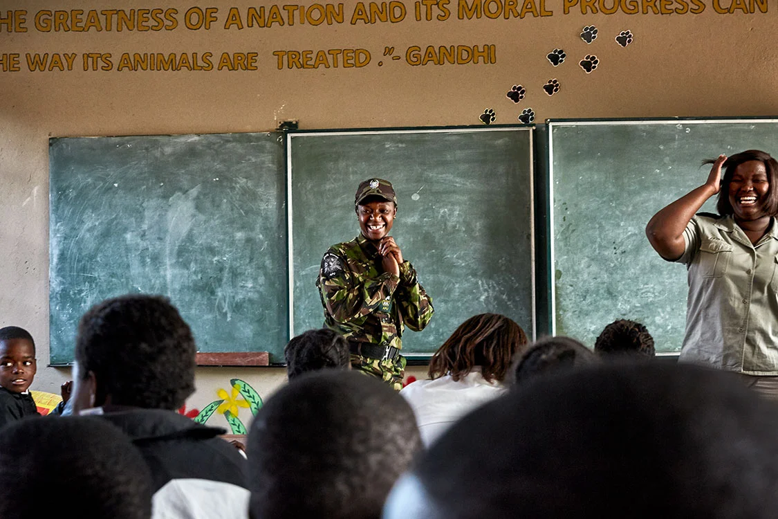 Black Mamba scout Nkateko Mzimba and Bush Babies education officer Lewyn Maefala laugh after realizing that three of the students in their class are the children of fellow Black Mambas, Maseke Primary School, South Africa, 2017. While Nkateko helps with Bush Babies for a few hours a week, Lewyn works on the program full-time. Lewyn works with very few resources, makes all her teaching materials herself, and spends most of her weekends preparing for next week’s lessons.