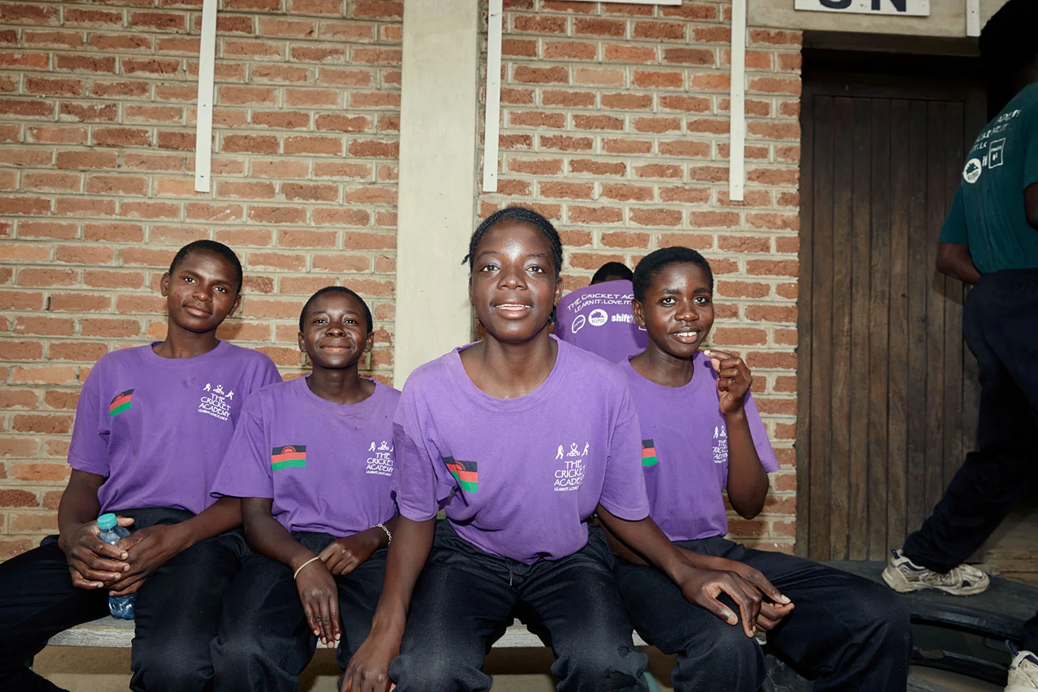 Shalani, Triphonia, Chimwemwe, and Tadala wait to begin their cricket theory class