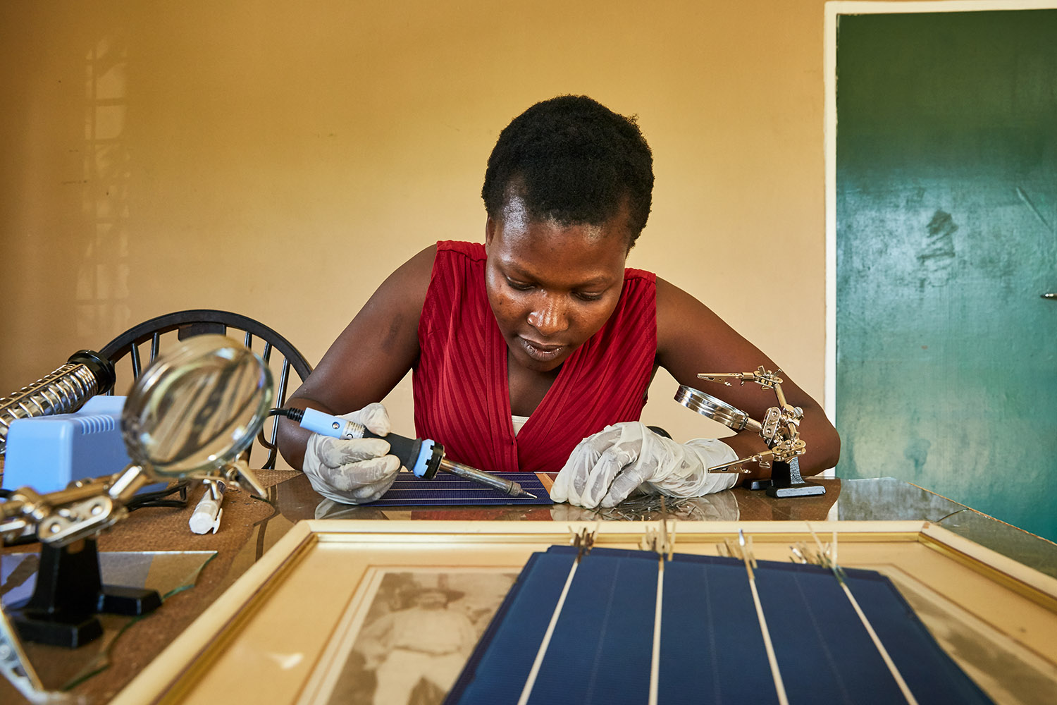  Jennifer, student at Green Malata, learn how to assemble solar panels, Luchenza, Malawi, 2017.  Green Malata teaches a variety of renewable energy skills, including solar panel building and maintenance, biogas generation, and wind turbines.  