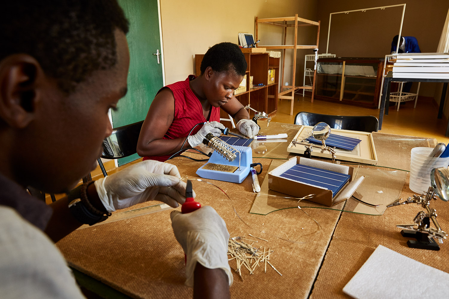  Alex and Jennifer, students at Green Malata, learn how to assemble solar panels, Luchenza, Malawi, 2017.  Green Malata teaches a variety of renewable energy skills, including solar panel building and maintenance, biogas generation, and wind turbines