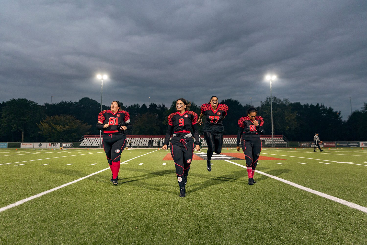  Left to right: Amsterdam Cats center Michelle, quarterback Kelly, center guard Sitara and defensive back Rufina walk back to the rest of the team after winning the coin toss before the first and only game of the 2020-2021 season against the Rotterda