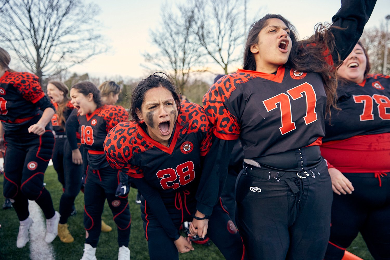  Dami (left), a running back for the Amsterdam Cats, and her sister Sitara, a center guard, celebrate an interception by the Cats' defense during the 2021 Queens Bowl matchup against the Rotterdam Ravens, Amsterdam, NL, 2021. 