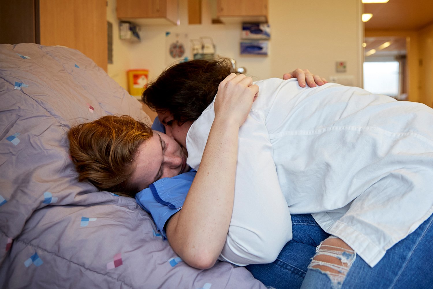  Dominique, quarterback for the Zwolle Blue Jays, hugs her girlfriend, Ricky, just before being taken into an operating room to have tendons in her left knee repaired, Zevenaar, NL, 2021. 