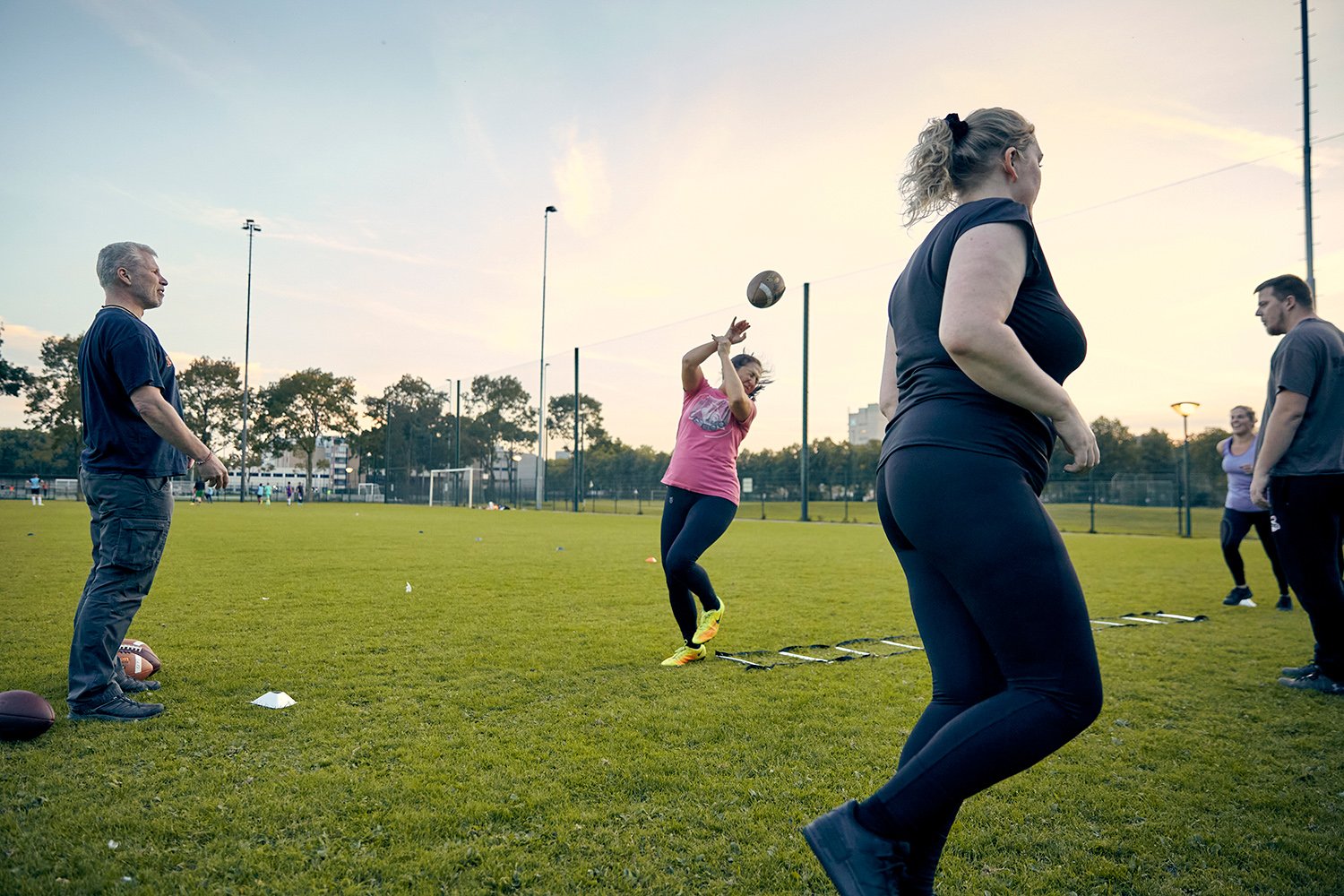  Head coach Arrien (left) tests the skills of Valkyries hopefuls during their first ever training session. Levina, the woman in the pink shirt, eventually made the team as a linebacker. She is still there. Eindhoven, NL, 2020. 