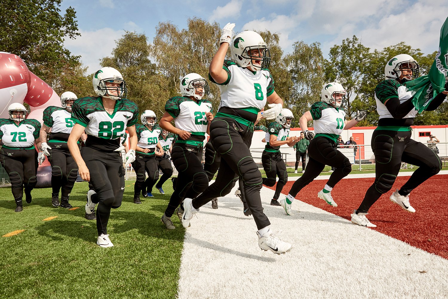  The Rotterdam Ravens run onto the field moments before a game against the Amsterdam Cats — their biggest rivals but which they've never beaten — in September 2021. 