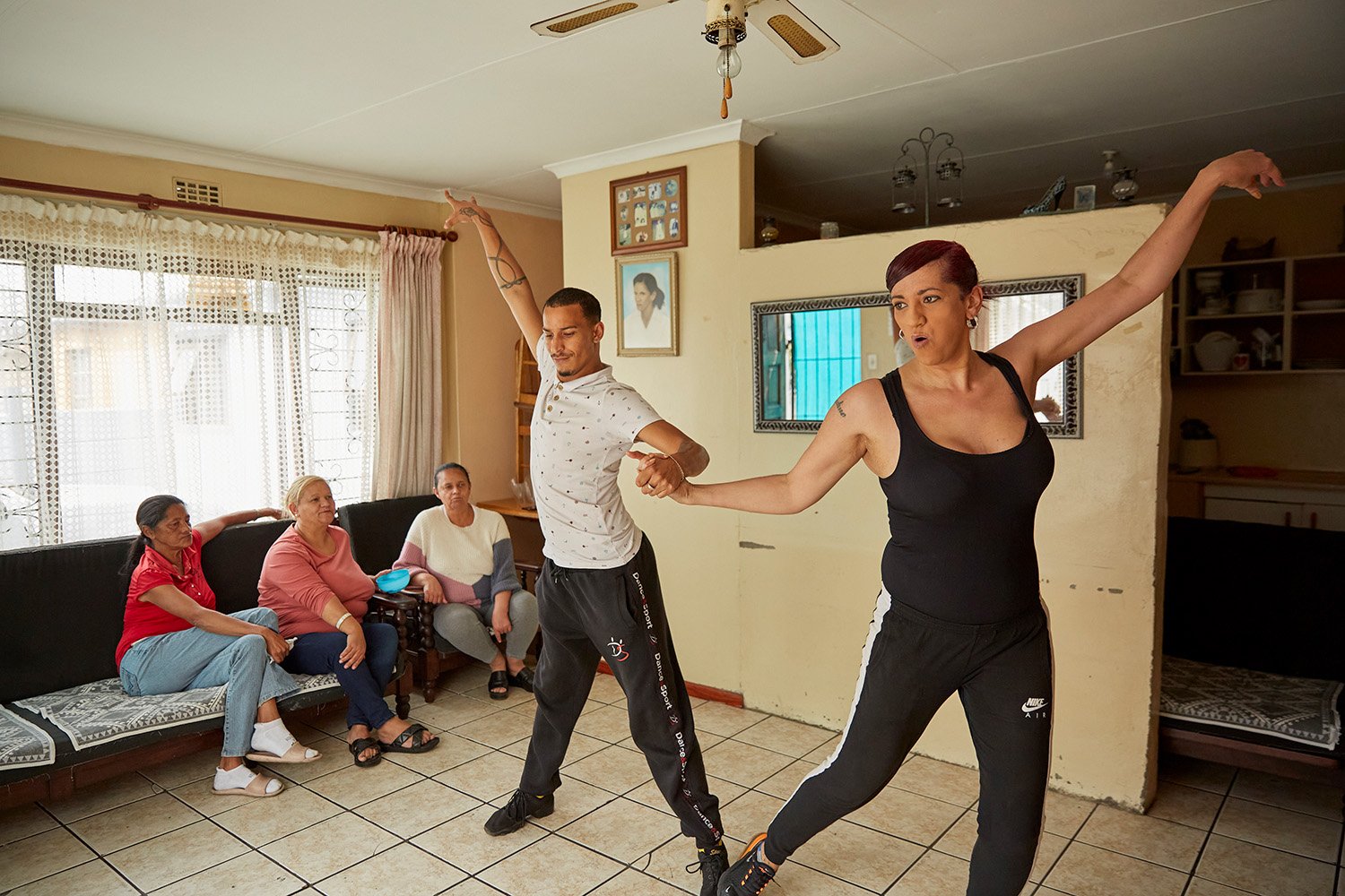  Chedino rehearses a dance routine with her dance partner, Shane, in the living room of her aunt Michelle (second from left), Belville, 2022.  