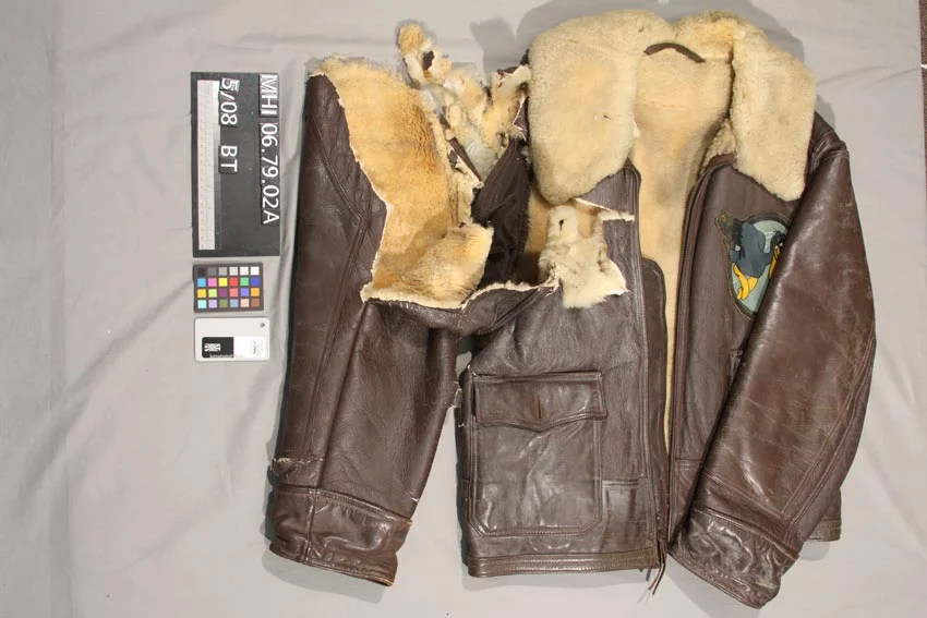 Before: flight jacket with ripped sleeve before conservation treatment