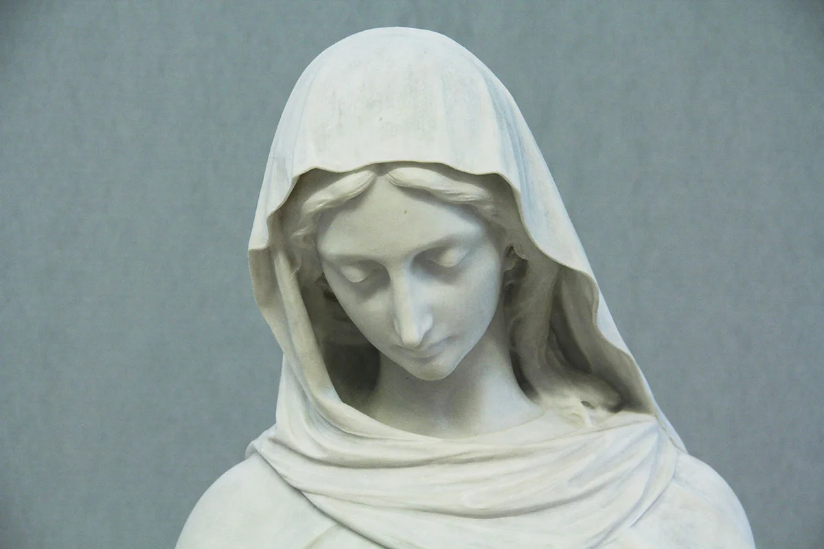 After sculpture restoration services and the removal of layers of flaking paint.
