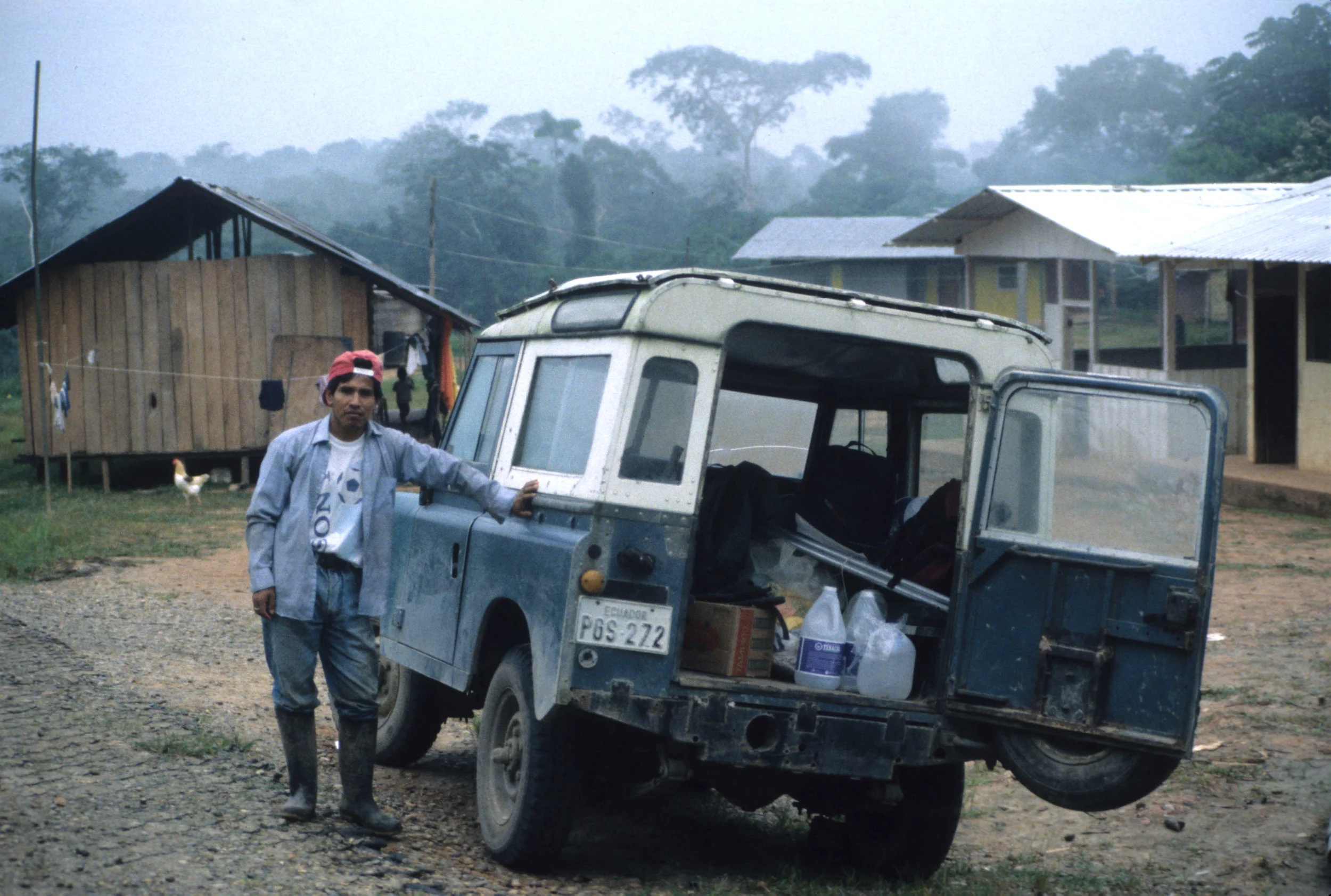    Huaorani Ethnic Reserve   , Ecuador, 1999   My friend Edmundo Pérez with our truck in a Huaorani village, getting ready for another day in the tree plots 