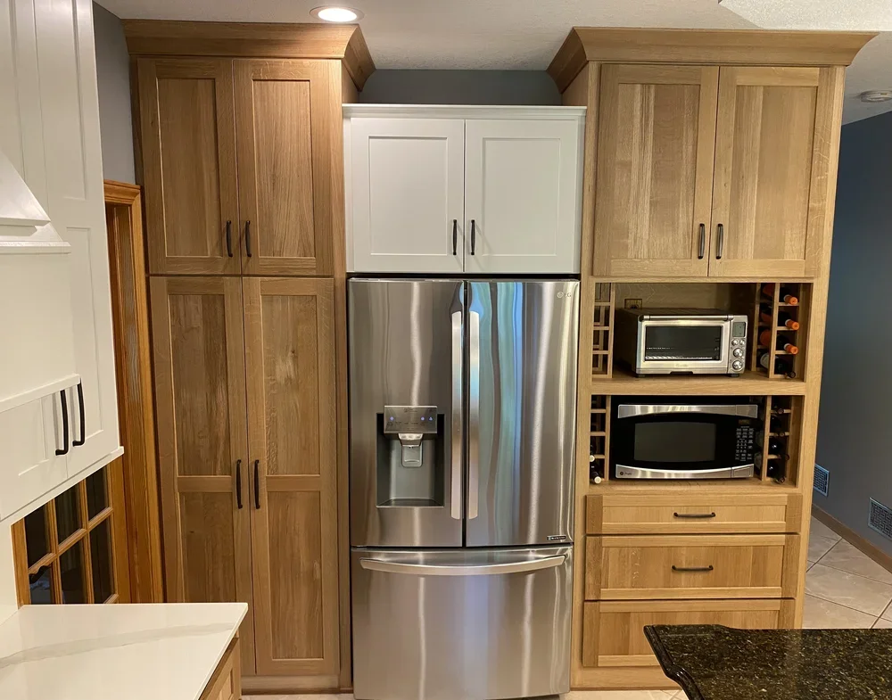 Rush River Interiors - Kitchen Cabinet Refacing - custom cabinets to surround fridge and built-in place for microwave and toaster oven.webp