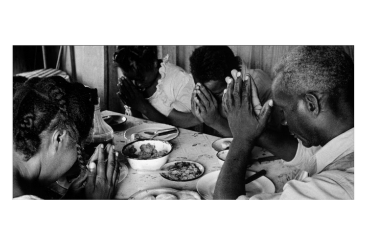 Black family praying at the table — Community as Agency