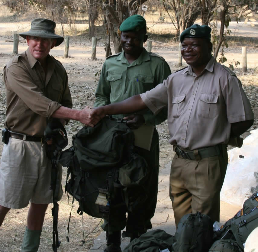 John Stevens of Zambezi Elephant Fund presenting a consignment of backpacks, water bottles, water sacs, cooking sets, sleeping bags to Bright Jeroma, Senior Ranger at Mana Pools, for use by anti-poaching Rangers in Mana Pools National Park.