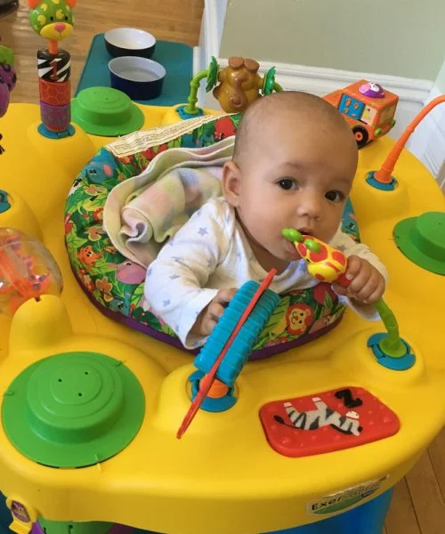 She explores the exciting toys on the Exersaucer