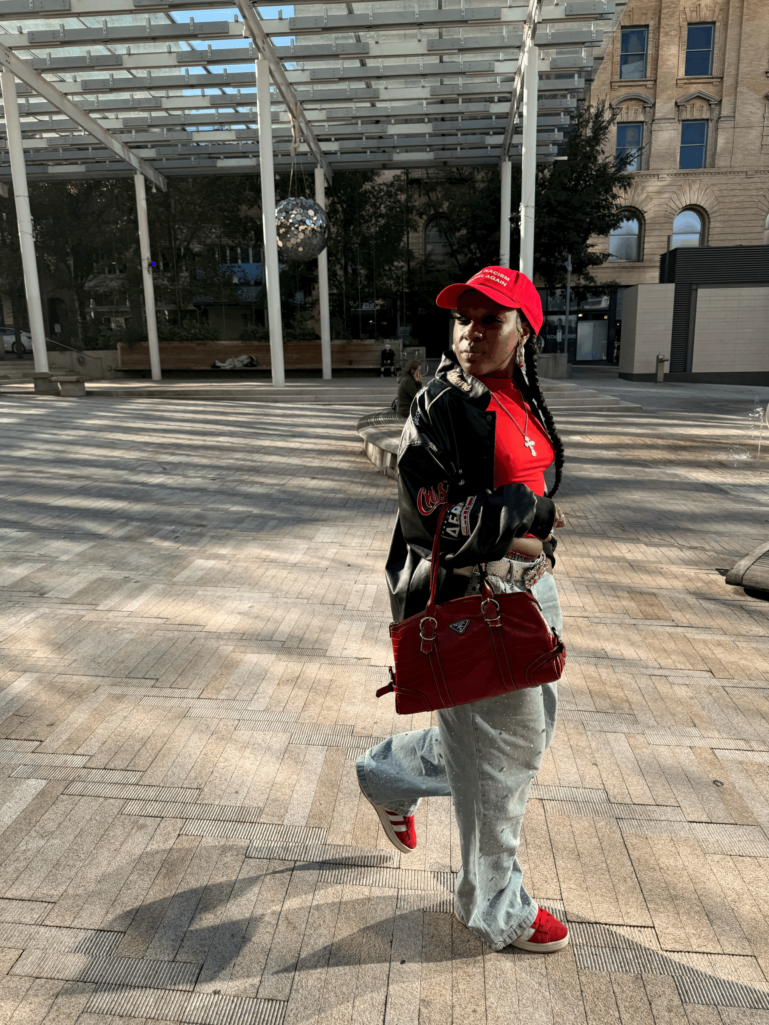 Mimi's Fresh Tees Make Racism Wrong Again Red Hat walking picture at Directors Park in Downtown Portland