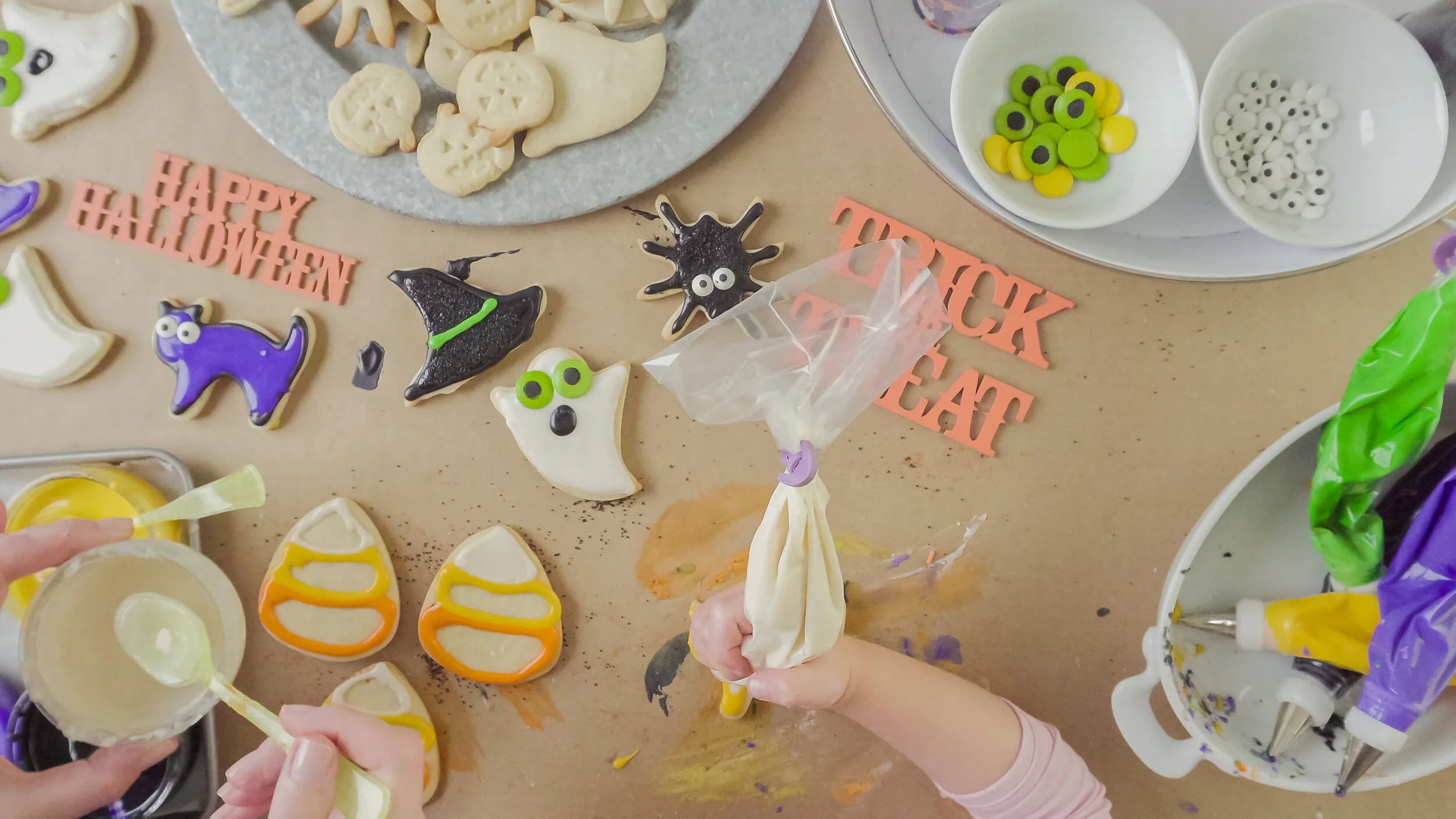 Mother-and-daughter-decorating-Halloween-sugar-cookies-861783304_3500x1969.jpeg
