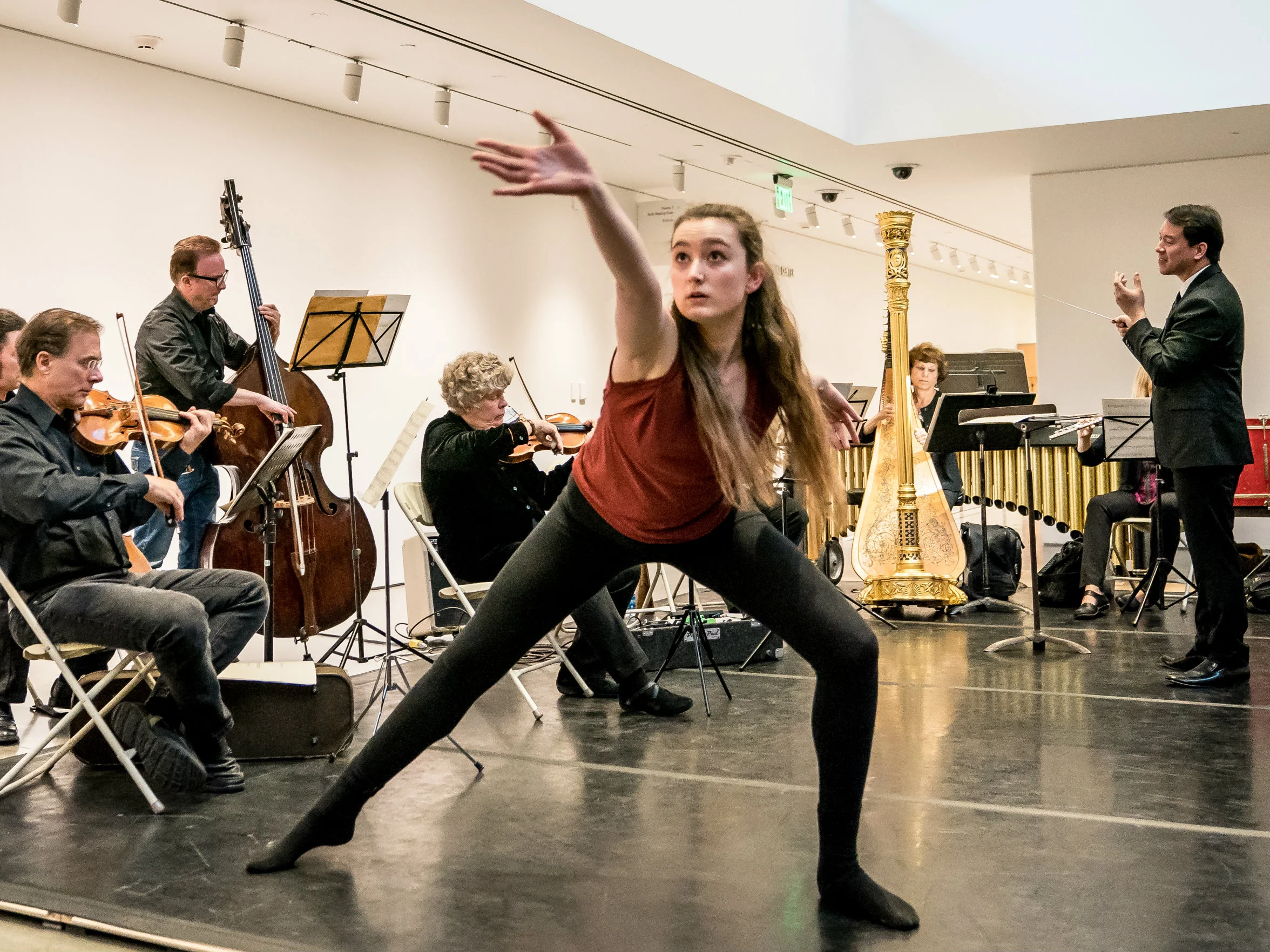 BBT Studio Company dancer in Vanessa Thiessen's From the Well of Echoes with members of the Berkeley Symphony at Berkeley Art Museum and Pacific Film Archive (BAMPFA) , photo by David S. Weiland