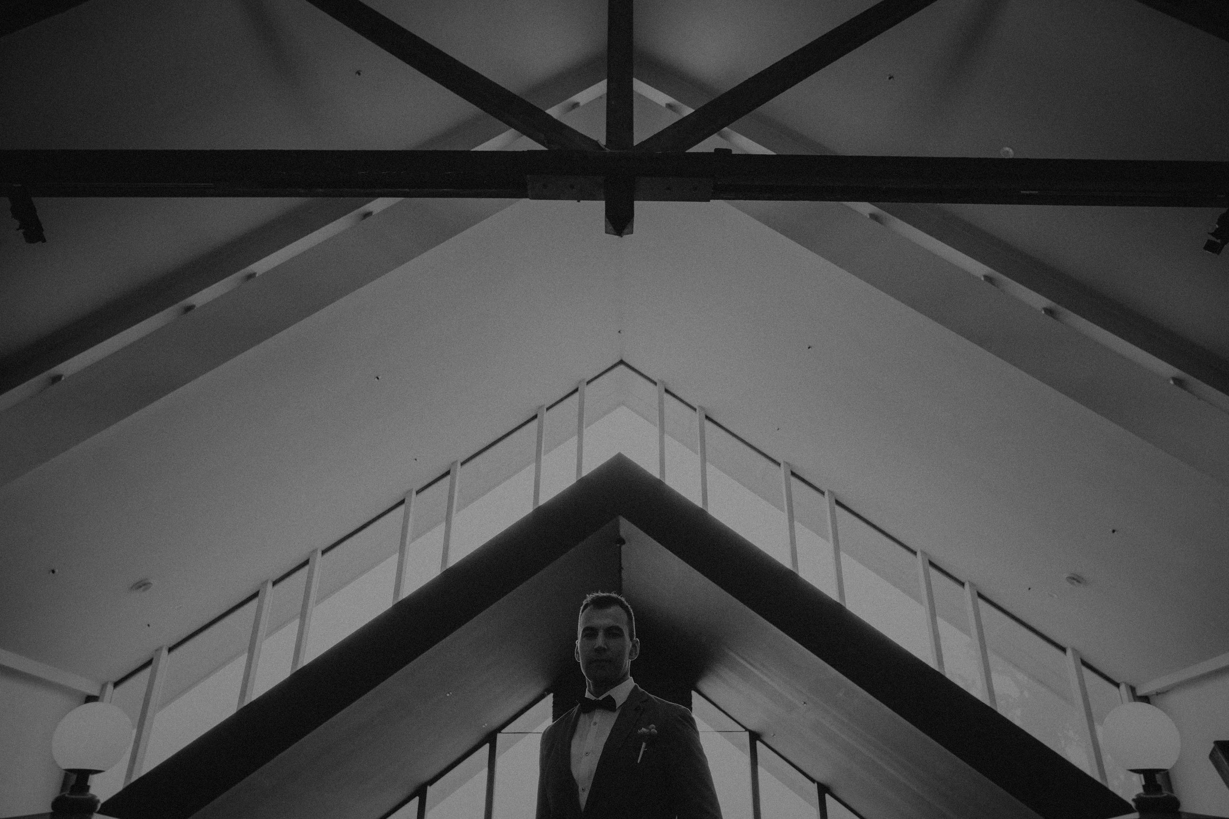A groom poses for a portrait at the Fairmont Resort in Leura