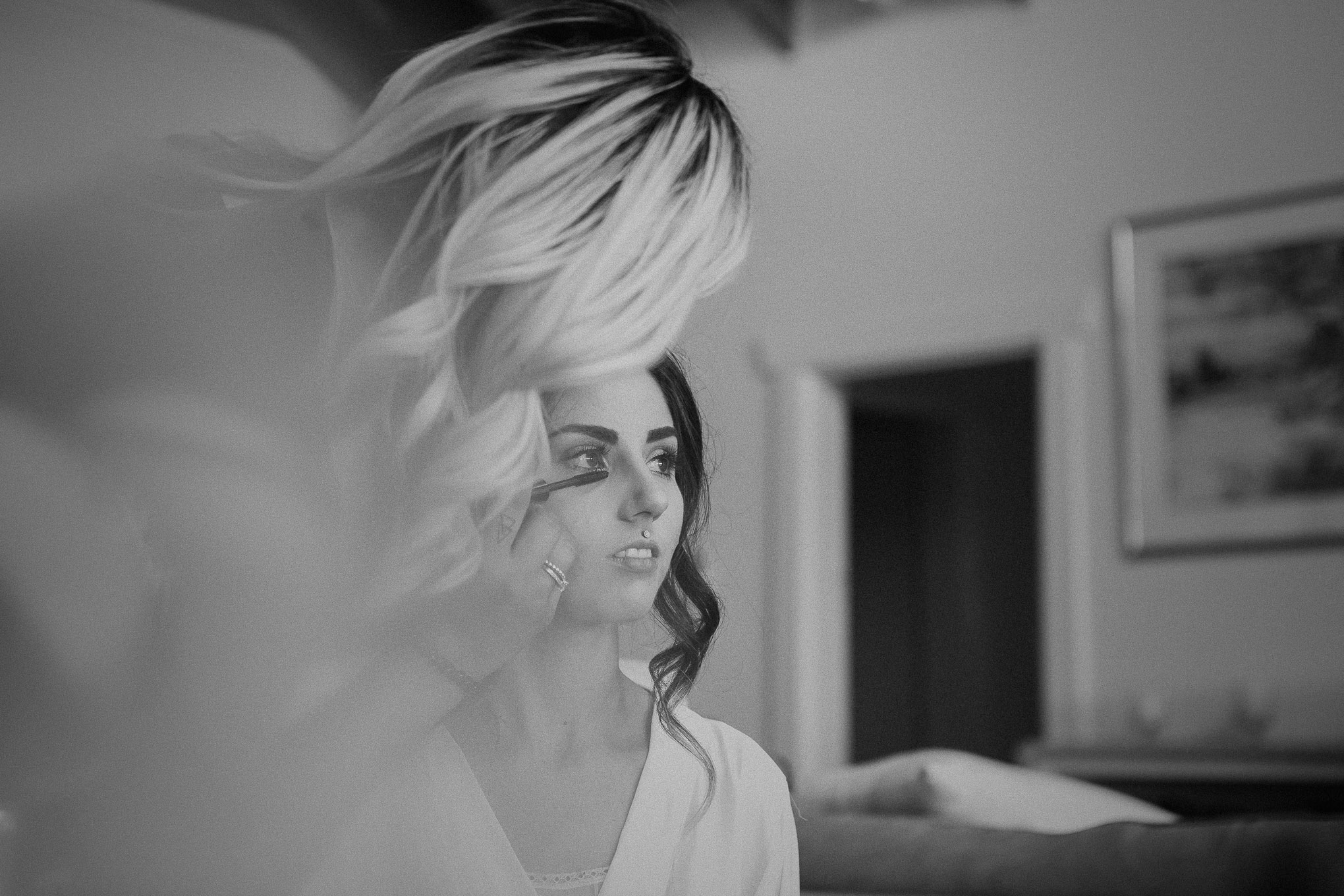 Bride having her makeup done before her wedding