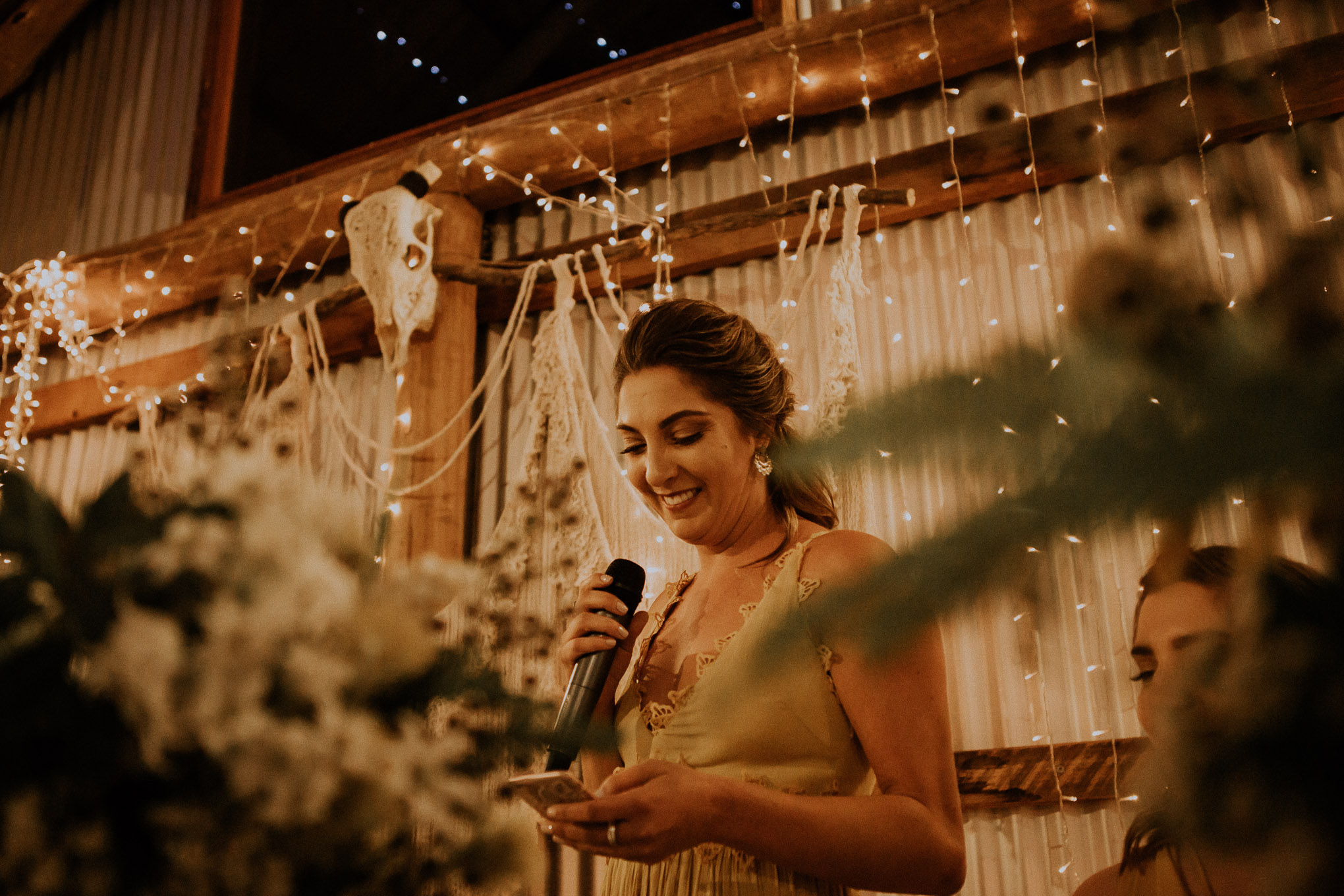Emotional speeches during a heartfelt wedding ceremony, with fairy lights and macrame
