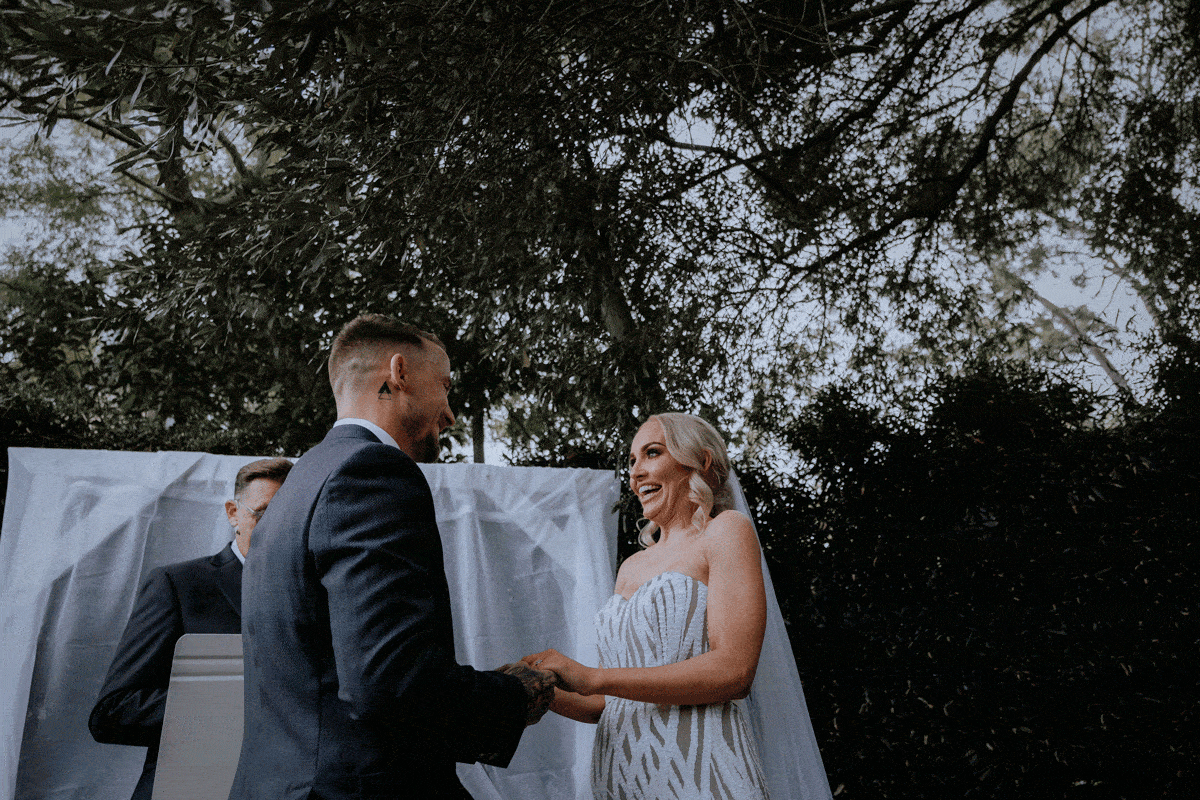 A husband and wife’s first kiss at their wedding in Sydney
