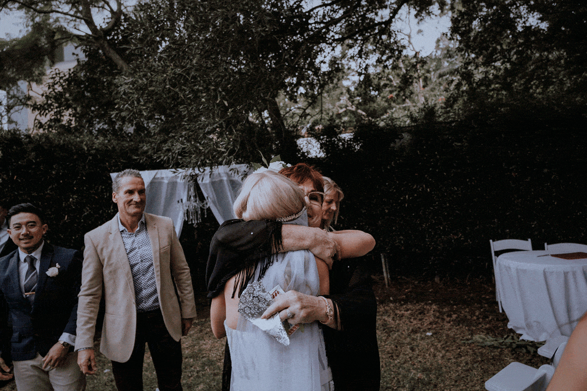 Emotional mum embraces her newly married daughter
